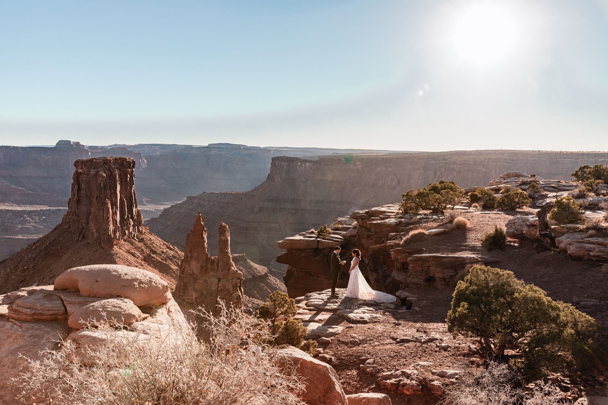 Bride and groom exchanging vows during their intimate ceremony at Malboro Point in Moab, Utah.