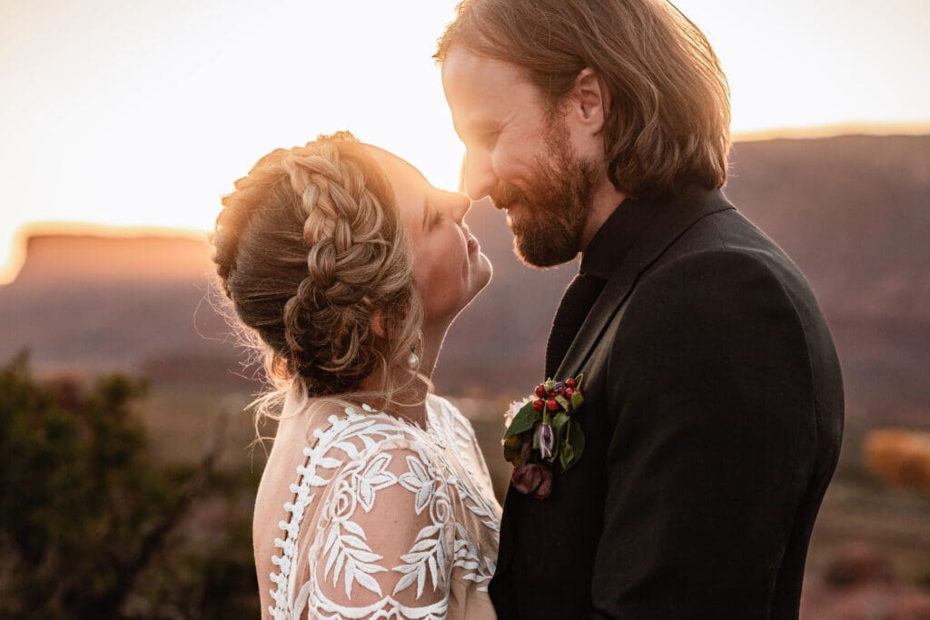 Bride and groom sharing a tender embrace at Hauer Ranch, capturing romantic candid moments in Moab.