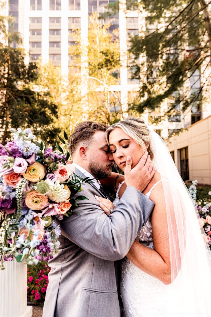 Bride and groom embracing during garden portraits at Pittsburgh Airport Marriott wedding