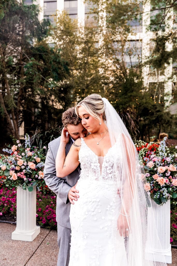 Bride and groom embrace in the garden at their Pittsburgh Airport Marriott hotel wedding