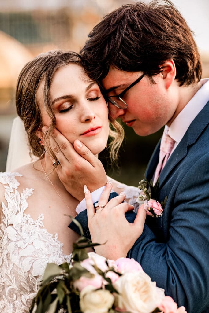 Close-up of bride and groom holding each other in the outdoor garden at Phipps Botanical Gardens during golden hour in Pittsburgh