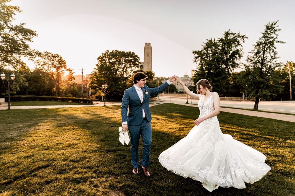 Pittsburgh groom spinning his bride on the front lawn of Phipps Botanical Gardens at golden hour