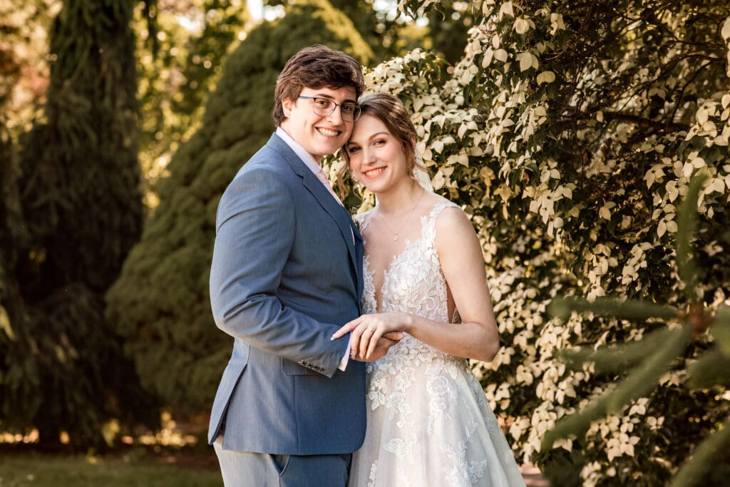 Close-up of bride and groom embracing in front of Phipps Botanical Gardens at golden hour in Pittsburgh