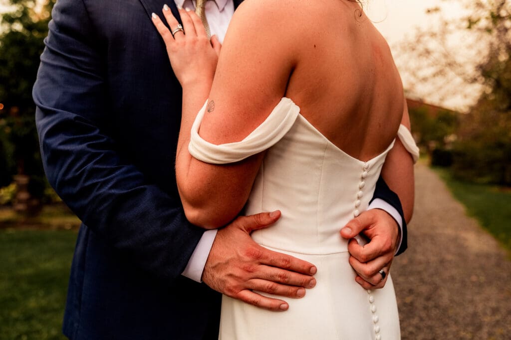 Close-up of bride and groom’s hands embracing during their Willowbrook wedding reception in Volant, Pennsylvania