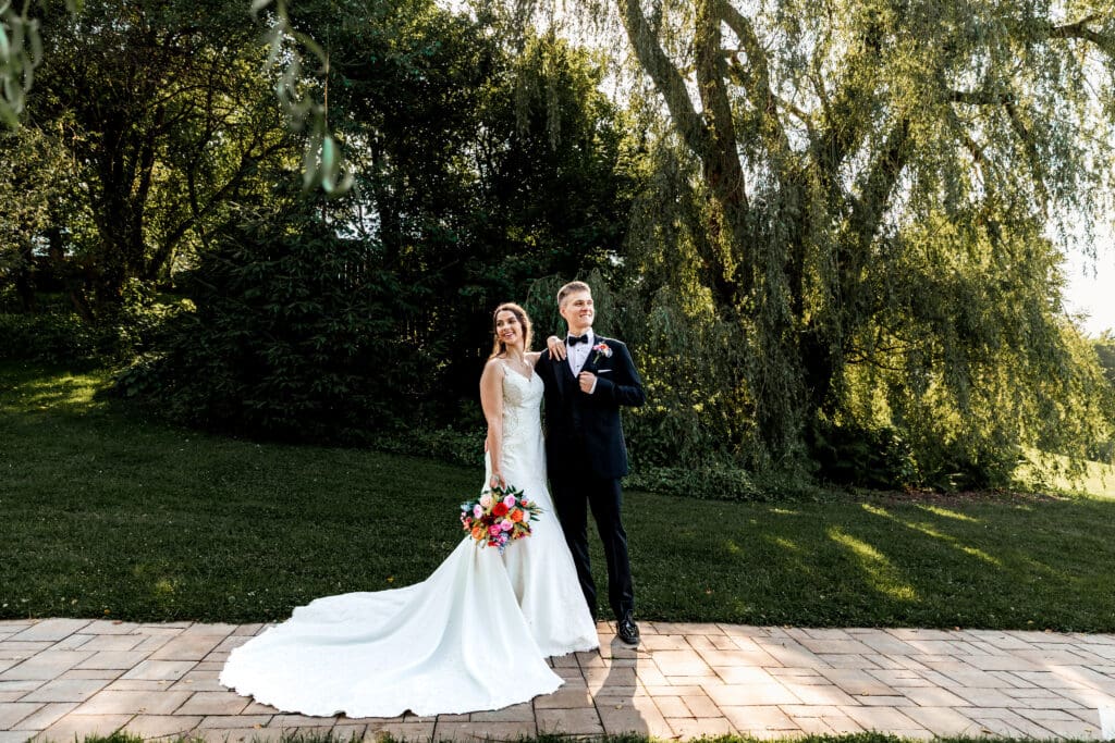 Romantic wedding portrait beneath willow trees at Willowbrook