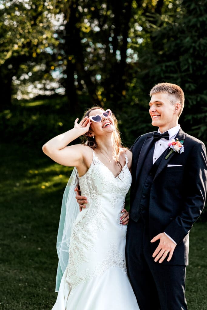 Bride and groom laugh together during golden hour portraits at Willowbrook