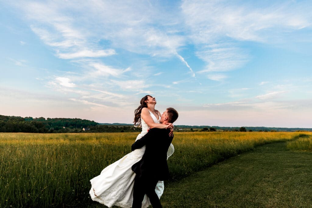 Couple embraces during golden sunset wedding portraits at Willowbrook