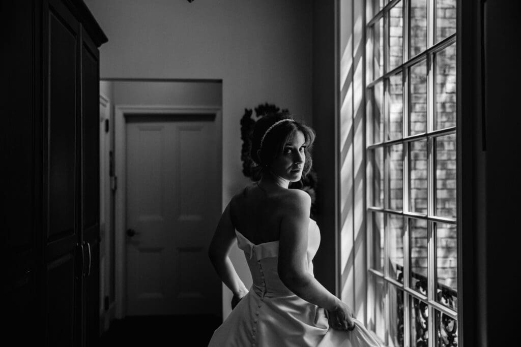 Bride glancing behind at camera in mansion during Succop Nature Park wedding session