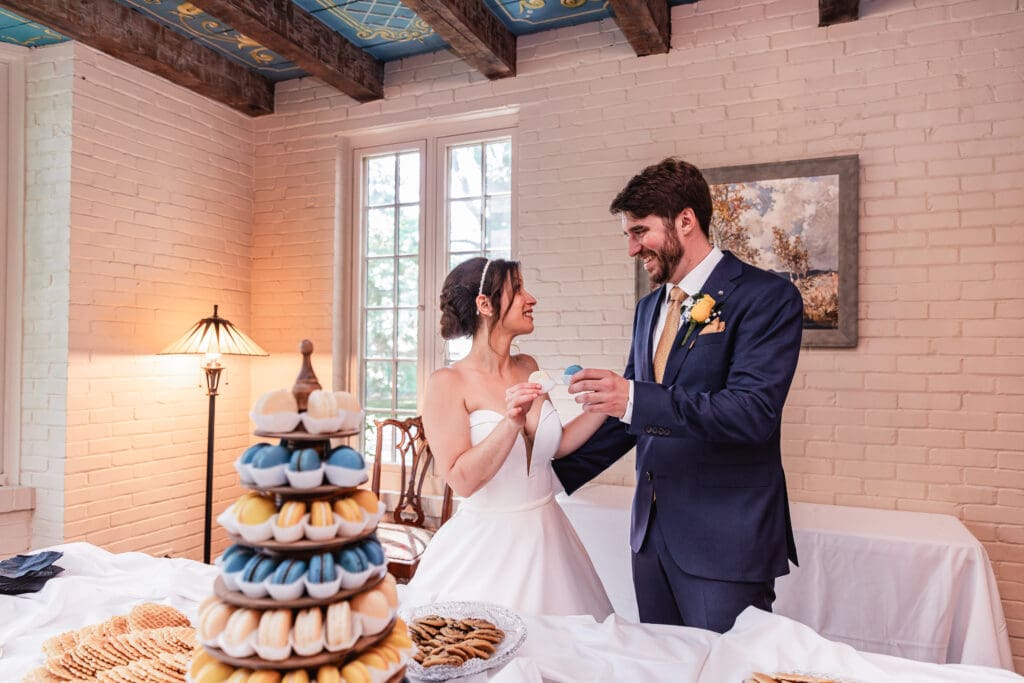Wedding couple cheers and enjoys macarons at Succop Nature Park reception