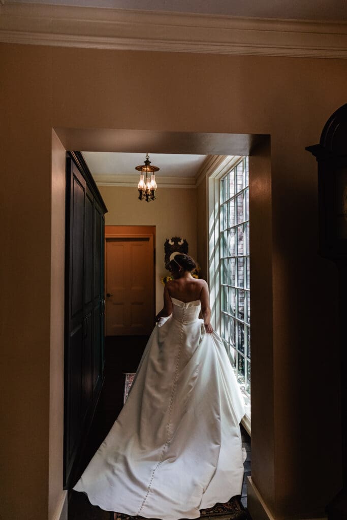 Bride walking down hallway in mansion at Succop Nature Park wedding