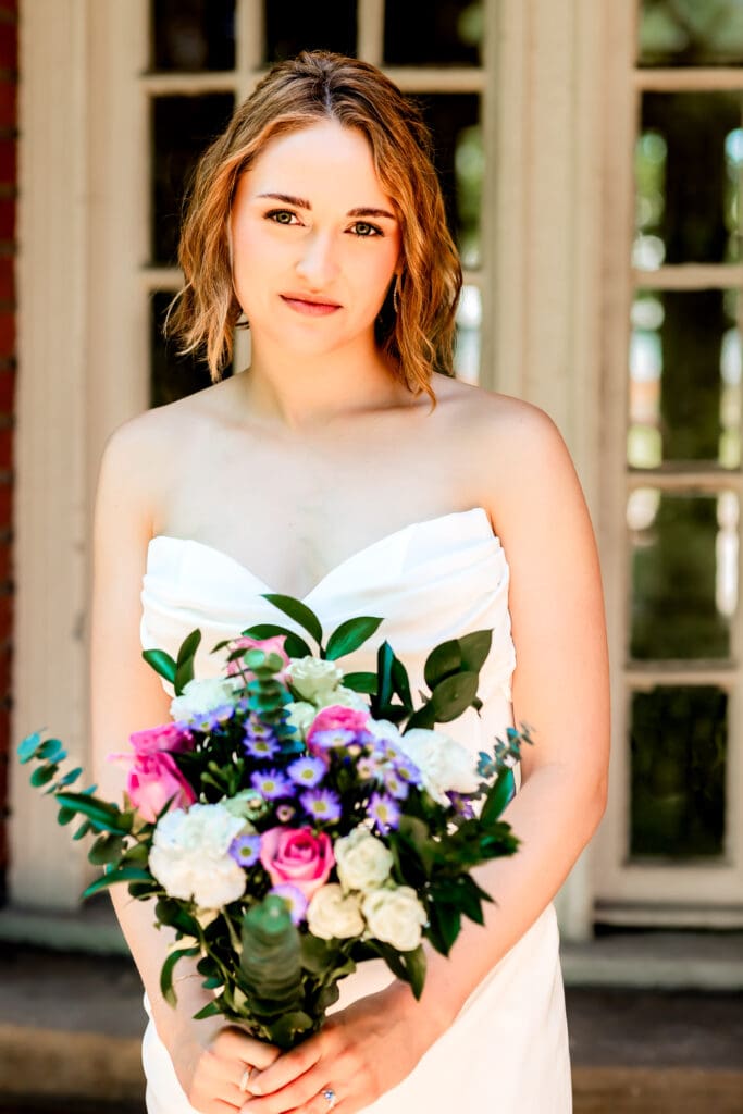 Bride holding her bouquet and looking at the camera during her Pittsburgh microwedding