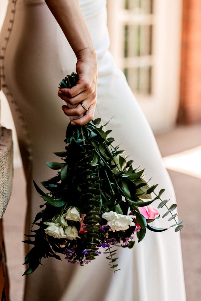 Close-up of spring wedding bouquet and bride’s bracelet at Schenley Park Welcome Center