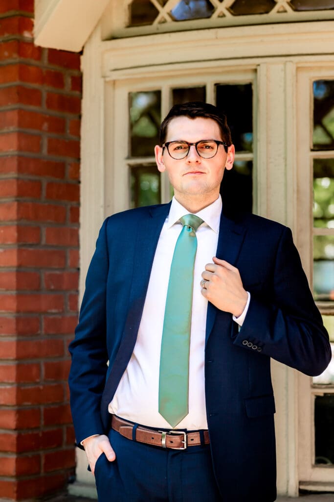 Groom posing confidently for the camera during his Schenley Park Welcome Center wedding day