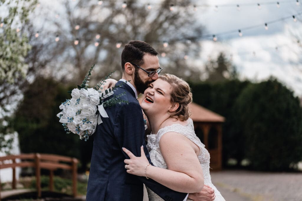 Joyful wedding portrait under string lights at The Atrium