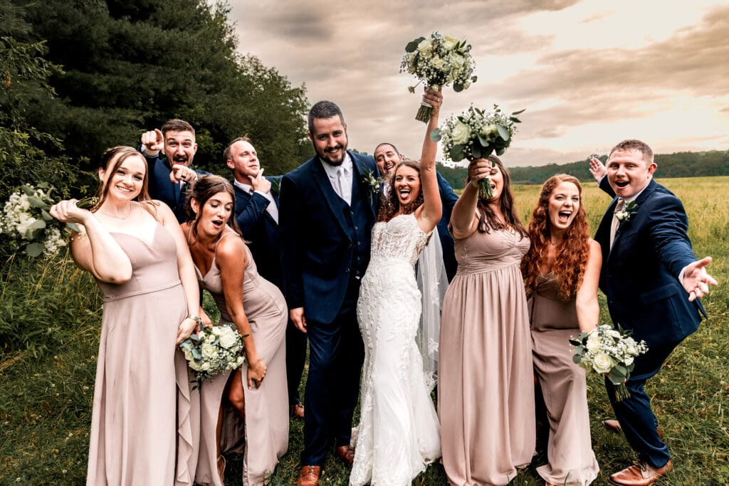 Wedding party cheering and celebrating the newlyweds at Sanaview Farm wedding in Somerset, PA