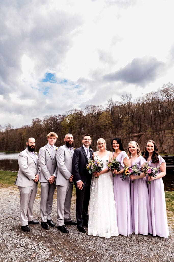 Wedding party members in formal attire gathered at Hopewell Community Park near The Fez