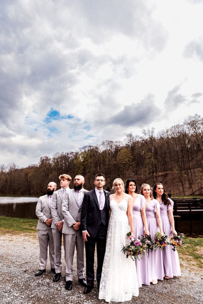 Wedding party gathered at Hopewell Community Park with autumn trees near The Fez