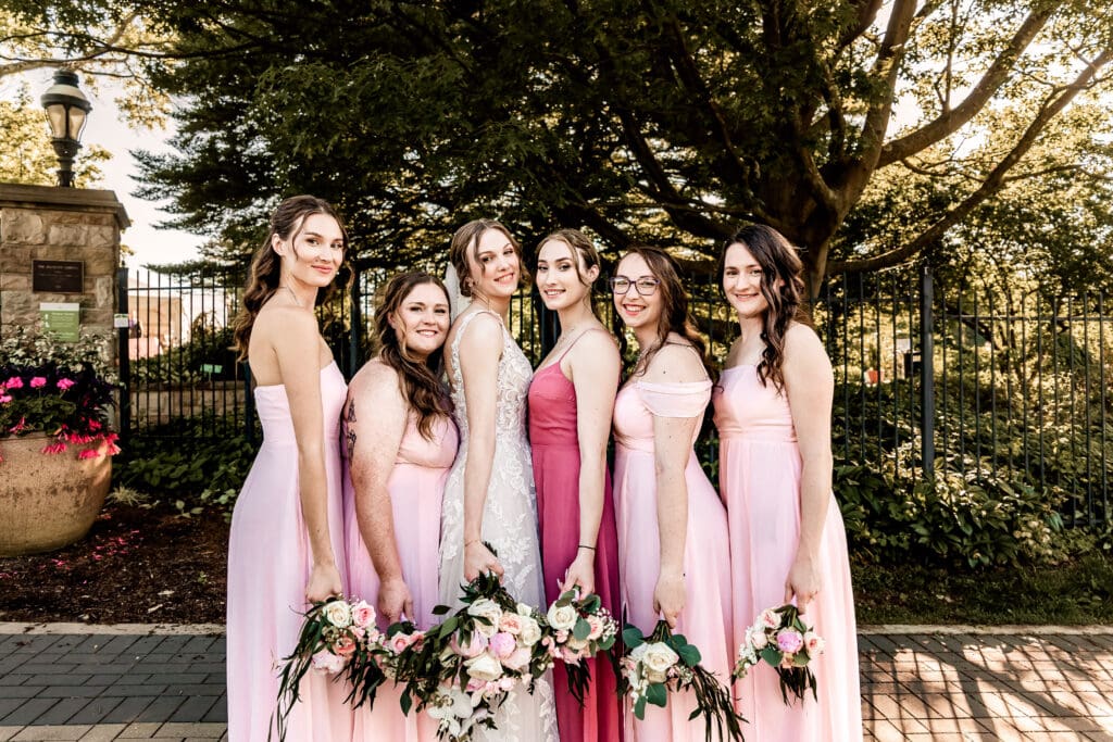 Pittsburgh bride and bridesmaids stand together and smile at the camera during a Phipps Botanical Gardens wedding