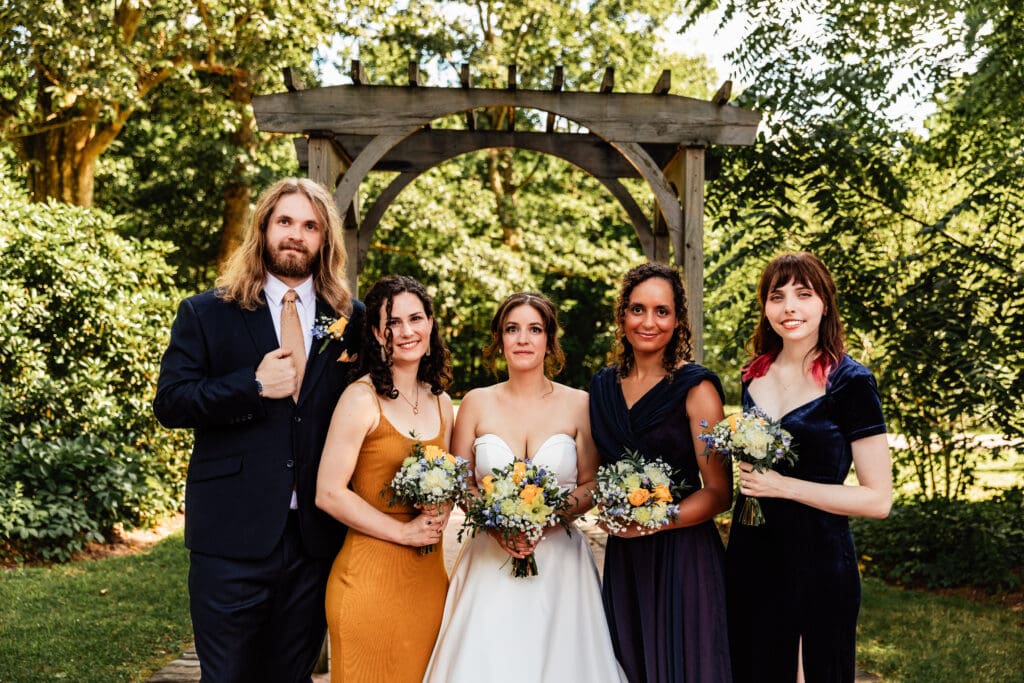 Bride posing with bridesmaids during wedding at Succop Nature Park