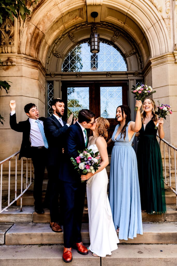 Wedding party cheering and celebrating in front of Phipps Conservatory in Pittsburgh