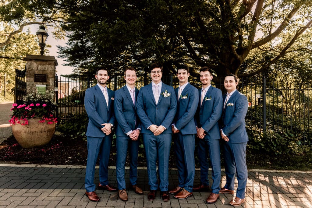Pittsburgh groom and groomsmen standing and smiling at the camera during a Phipps Botanical Gardens wedding
