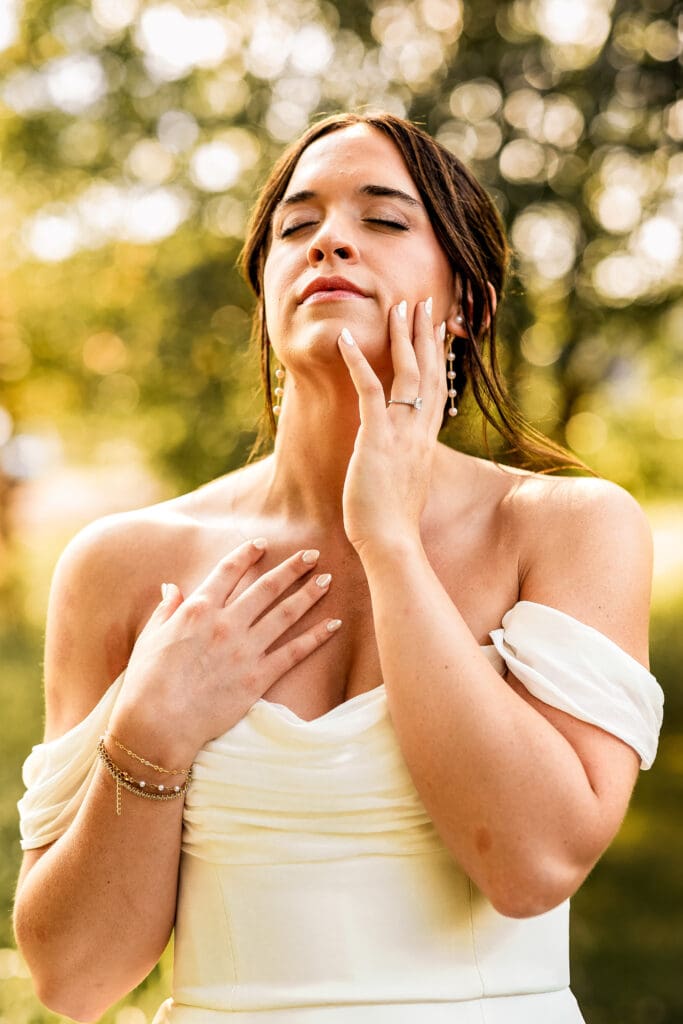 Pittsburgh bride gently touching her face during wedding portraits at Willowbrook in Volant, Pennsylvania