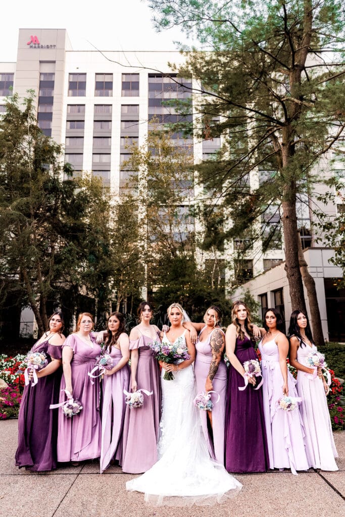 Bride and bridesmaids posing together in the garden at Pittsburgh Airport Marriott wedding