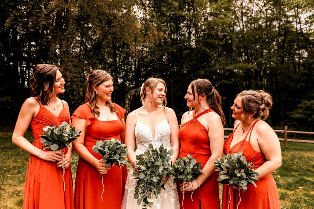 Bride and bridesmaids sharing laughter during wedding portraits at The Barn at Ever Thine in Fenelton, Pennsylvania
