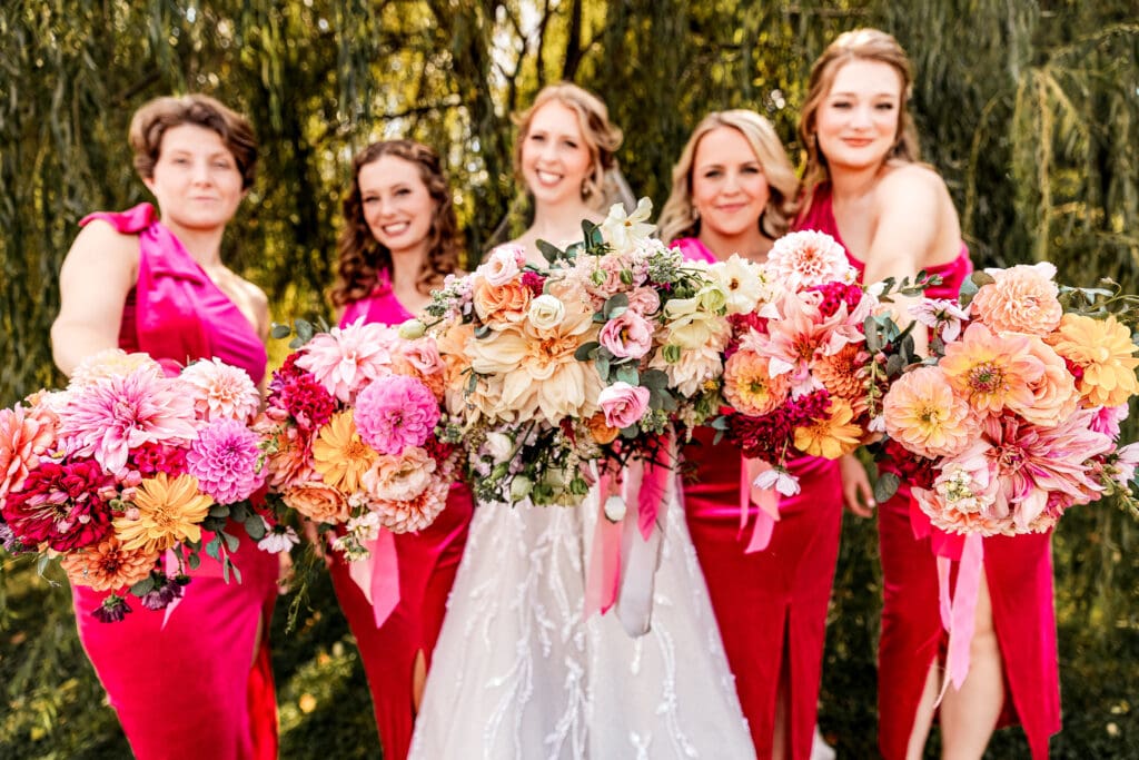 Pittsburgh bride surrounded by bridesmaids during portraits at The Gathering Place at Darlington Lake