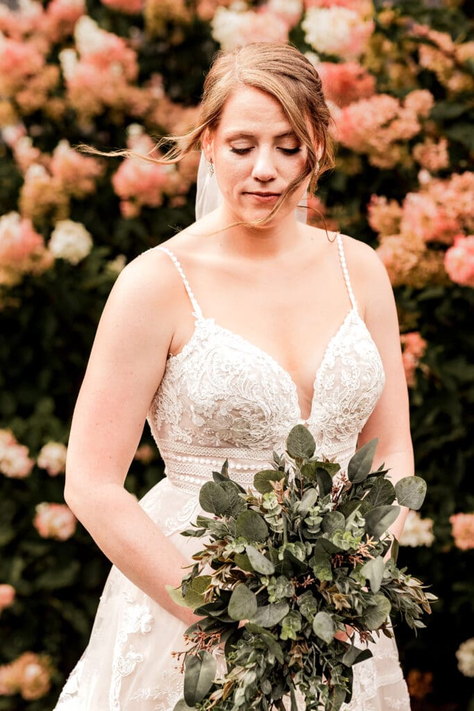 Bride looking down at her bouquet during wedding portraits at The Barn at Ever Thine in Butler County, PA