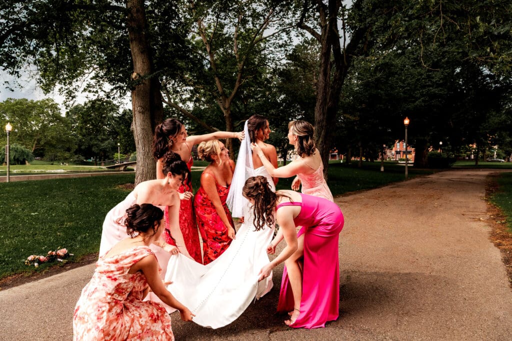 Bridesmaids fixing hair and helping bride get ready at National Aviary wedding