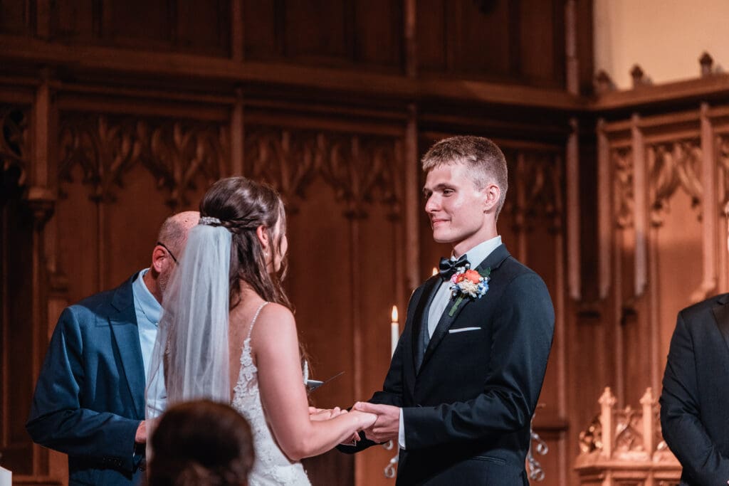 Couple exchanges vows during a traditional church wedding ceremony