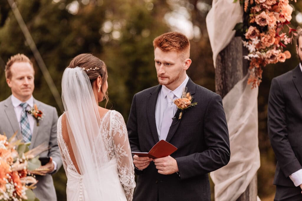 Bride and groom share emotional personal vows during their ceremony at The Barn At Ever Thine