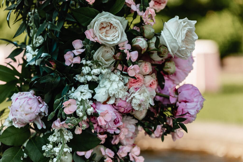 Close-up of lush florals on the circular arbor at Phipps Botanical Gardens during a Pittsburgh wedding