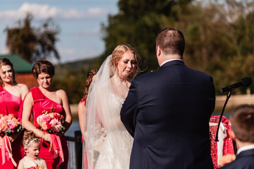 Bride getting emotional at the altar during ceremony at The Gathering Place at Darlington Lake