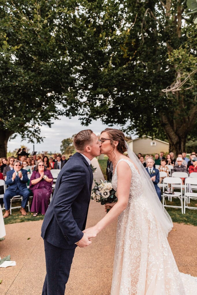 Pittsburgh wedding couple’s first kiss from officiant POV at Pinehall at Eisler Farm