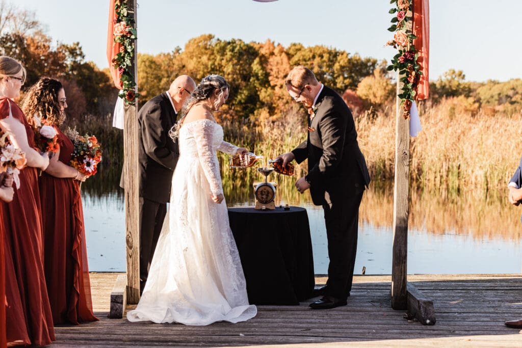 Wedding couple creates their own whiskey together during a unity ceremony at Willowbrook
