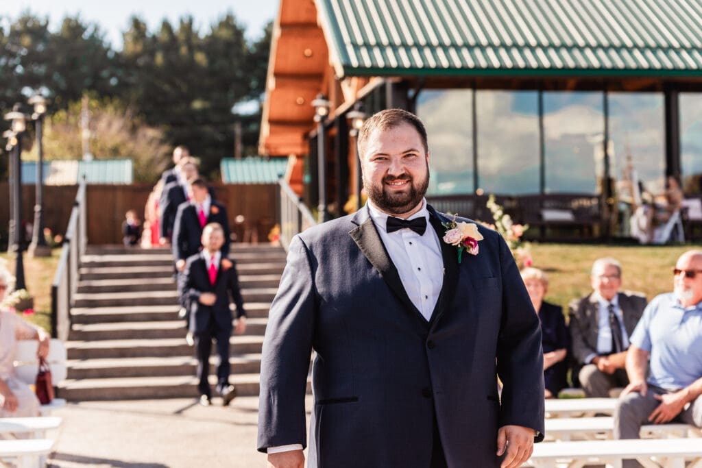 Groom walking down the aisle during wedding ceremony at The Gathering Place at Darlington Lake