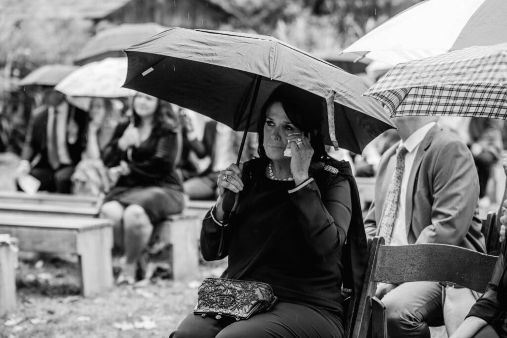 Mother wipes away tears as bride walks down aisle at Hinckston Run Farm