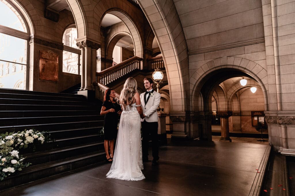 Wedding couple holding hands during their Allegheny County Courthouse ceremony