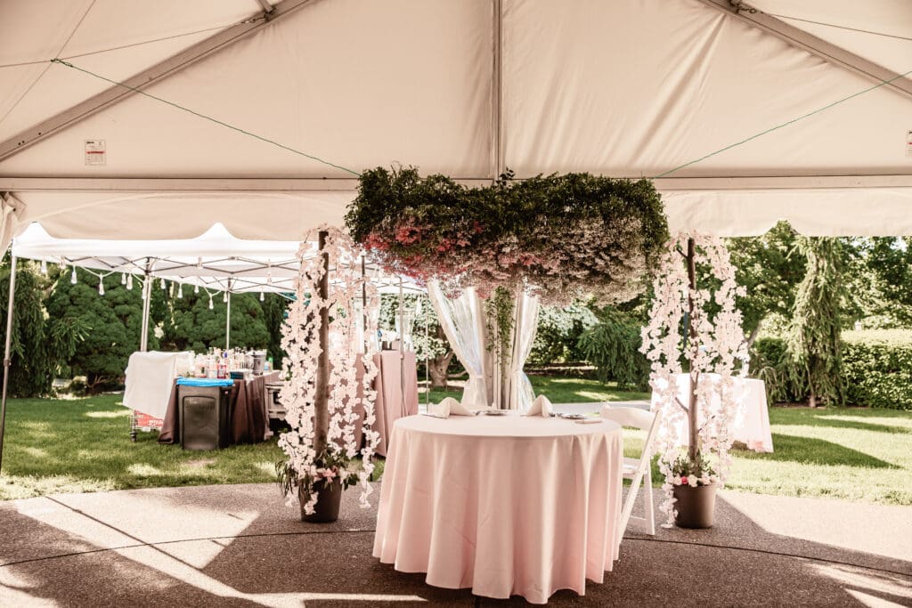 Pink flower cloud suspended above the sweetheart table at a Phipps Botanical Gardens wedding reception