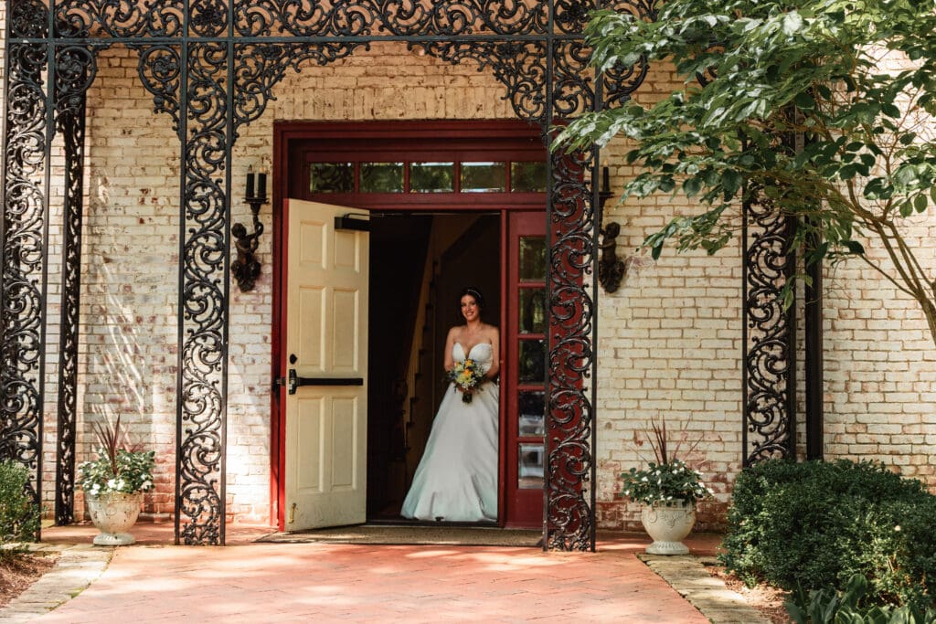 Bride making her ceremony entrance from mansion at Succop Nature Park