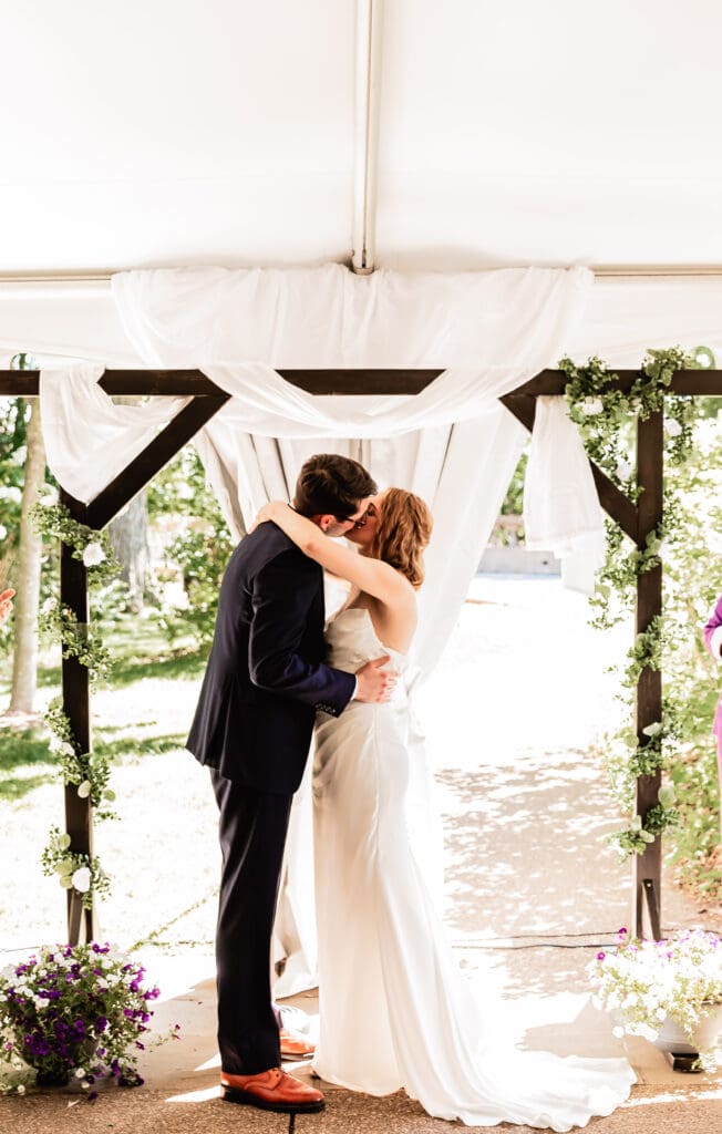 Bride and groom sharing their first kiss during a Pittsburgh microwedding ceremony