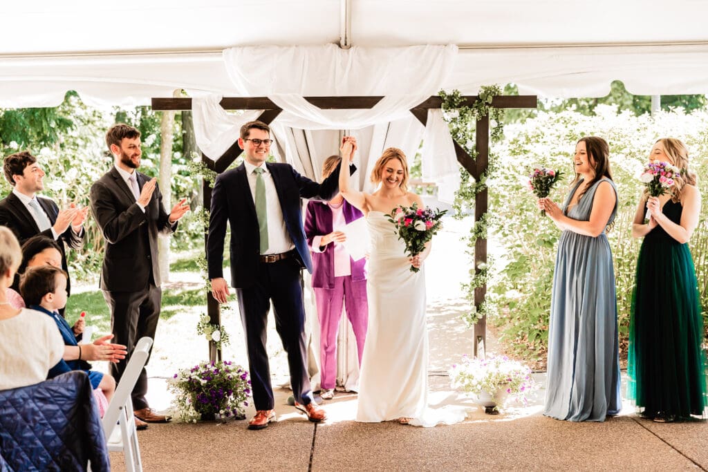Bride and groom celebrate at their ceremony at Schenley Park Welcome Center