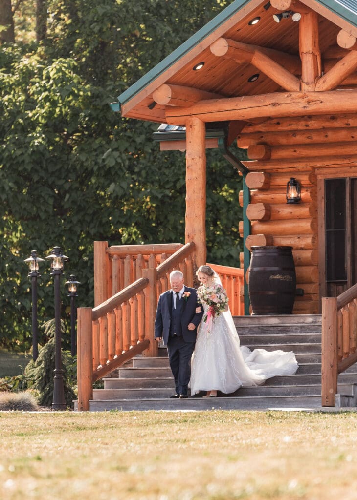 Bride being escorted down the aisle by her father at The Gathering Place at Darlington Lake