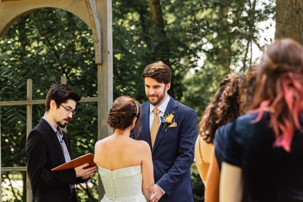 Groom delivering vows to bride during wedding ceremony at Succop Nature Park