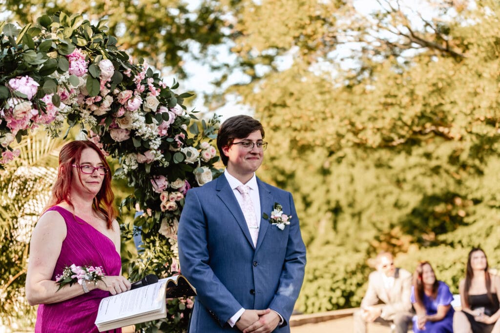 Pittsburgh groom standing at the altar looking at his bride during their Phipps Botanical Gardens wedding ceremony