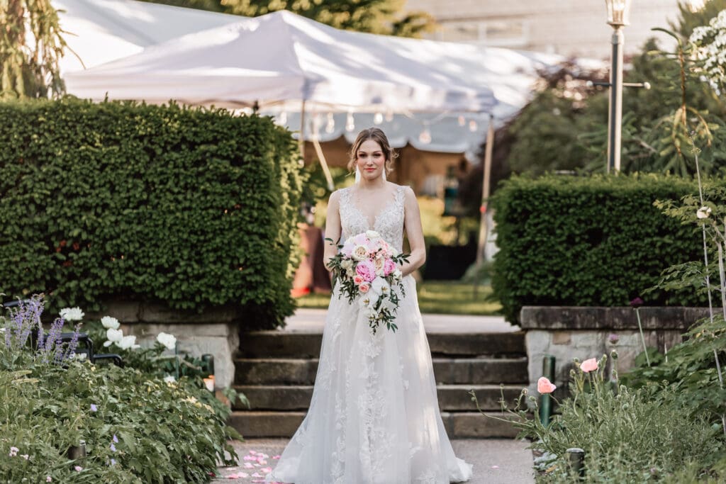 Bride walking down the aisle staring at her groom during a Pittsburgh Phipps Botanical Gardens wedding