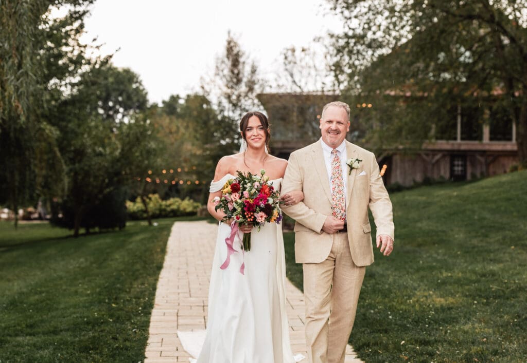 Pittsburgh bride escorted down the aisle by her father during a Willowbrook wedding ceremony in Volant, Pennsylvania