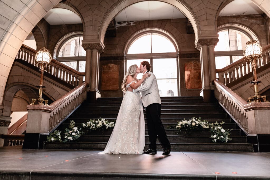 Bride and groom sharing their first kiss as husband and wife during a Pittsburgh courthouse wedding